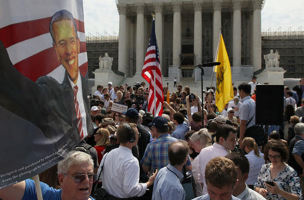 supporter holds a sign of President Barack Obama in front of the U.S. Supreme Court 