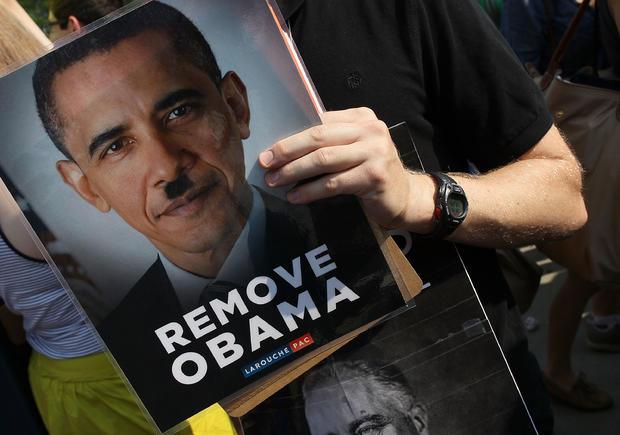 A protester holds a Remove Obama sign in front of the U.S. Supreme Court 