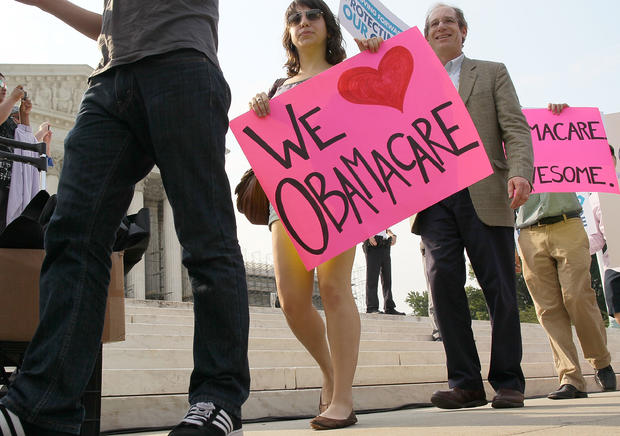 People march in support of the Obama administration's health care act 
