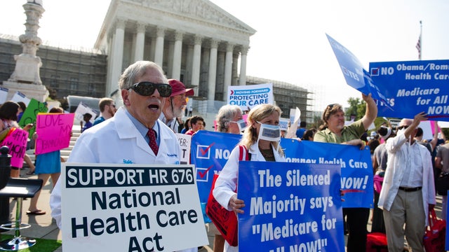 Demonstrators protest as they await a decision by the US Supreme Court 