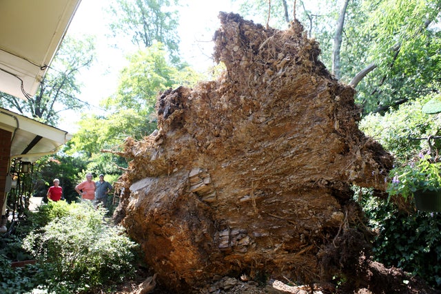 Martha and Charlie Boswell stand in their backyard with their neighbor Larry Richardson  