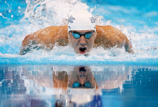 Michael Phelps swims to victory in the men's 100-meter butterfly  