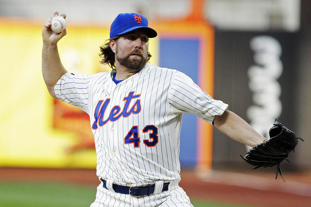 New York Mets pitcher R.A. Dickey delivers a knuckleball pitch in