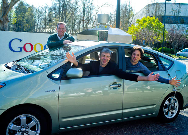 Google's top leaders pose in a Google self-driving car. From left to right  are Executive Chairman Eric Schmidt, Chief Executive Larry Page, and co-founder Sergey Brin. 