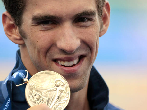 Michael Phelps shows his gold medal  