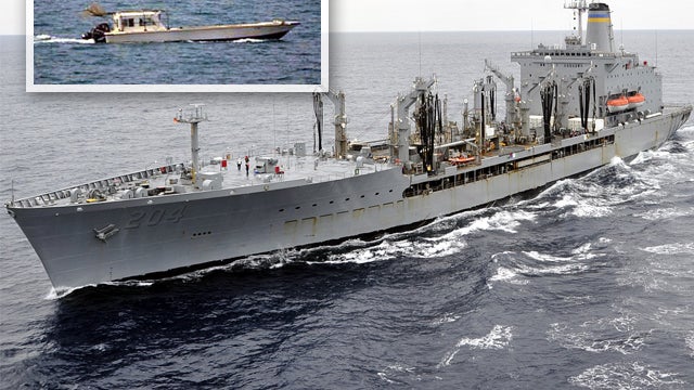 A small vessel that was fired upon by the U.S. Navy off Dubai's coast July 16, 2012, is inset in a picture of the replenishment oiler USNS Rappahannock sailing in the Pacific Ocean Oct. 4, 2011. 