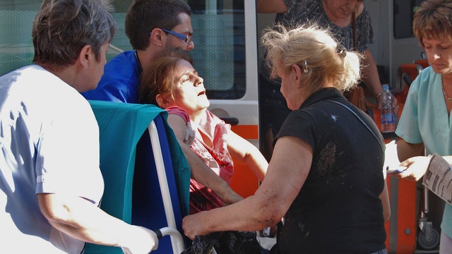 An unidentified injured Israeli tourist is carried in front of Borgas hospital after an explosion at Burgas airport, outside the Black Sea city of Burgas, Bulgaria. 