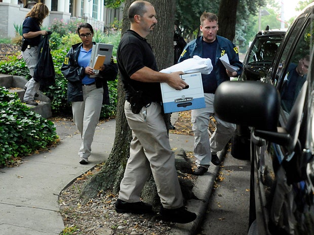 FBI agents load a box of materials into an SUV outside Trenton, N.J., Mayor Tony Mack's house July 18, 2012, following a middle-of-the-night raid.