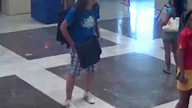 This image taken from CCTV provided by the Bulgarian Interior Ministry Thursday July 19, 2012 who claim it shows the unidentified bomber, center, with long hair and wearing a baseball cap, at Burgas Airport in Burgas, Bulgaria on Wednesday, July 18, 2012. 