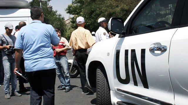 U.N. observer vehicle arrives at the site where a bomb attack hit the National Security building in Damascus 