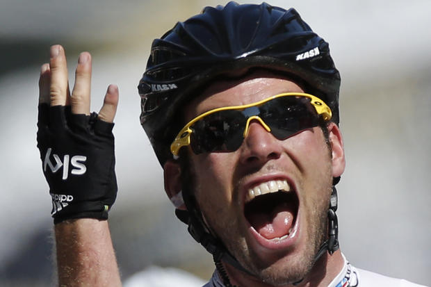 Mark Cavendish of Britain flashes four fingers as he crosses the finish line  