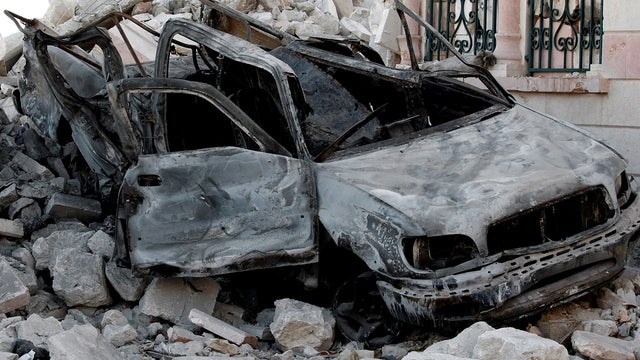a damaged vehicle from clashes between Free Syrian Army soldiers and Syrian government troops  