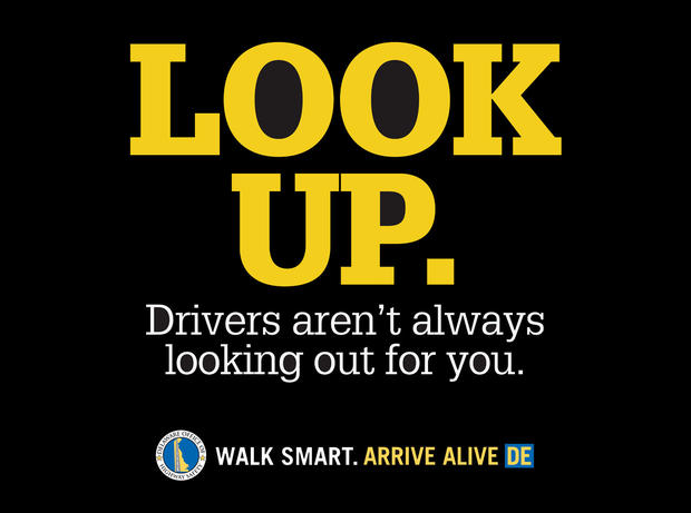 The Delaware State Office of Highway Safety created signs aimed at getting distracted pedestrians to look up from their mobile devices and watch where they're walking. 