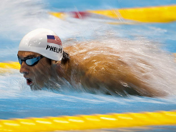 Michael Phelps of the USA explodes out of the water in his swimming heat in the Men's 200m Butterfly at the Olympic Games in London on July 30, 2012.  