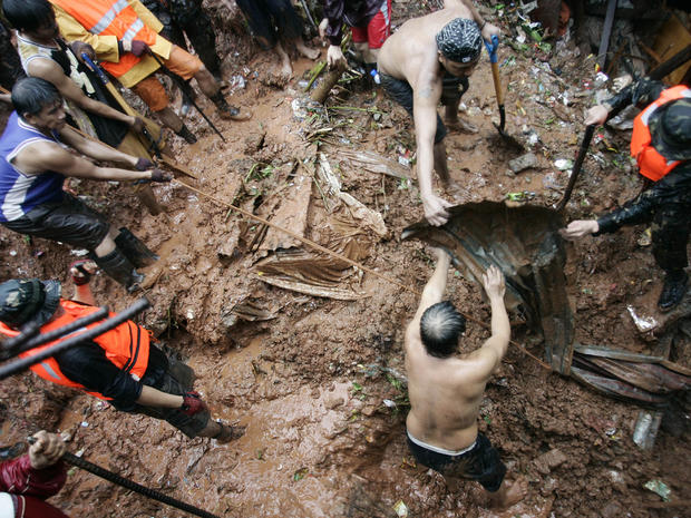 Filipino rescuers dig for survivors where four homes collapsed in a landslide 