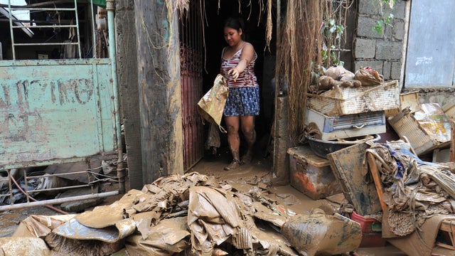 A resident cleans her home in the suburbs of Manila 