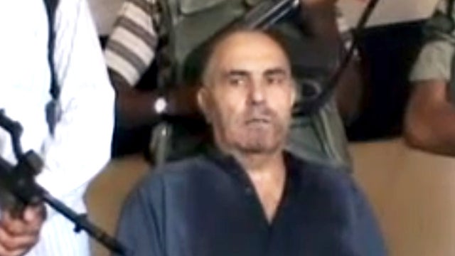 An image from an amateur video released by the Shaam News Network purports to show Syrian Pilot Colonel Rafik Mohammed Suleiman being interrogated by rebel officers after his Soviet-made MiG warplane was apparently hit by ground fire over Deir el-Zour pro 