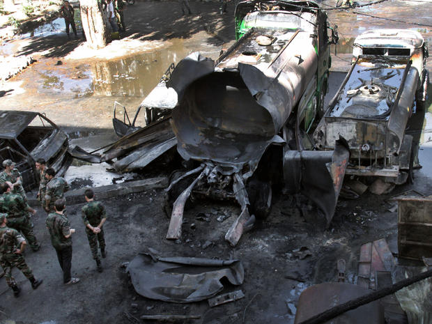 Syrian security investigate after a bomb attached to a fuel truck exploded outside a hotel 