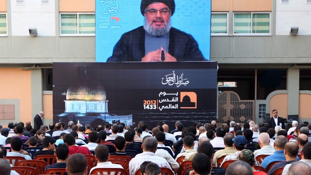 Hezbollah leader Sheikh Hassan Nasrallah speaks via video in the southern suburb of Beirut, Lebanon, Friday, Aug 17, 2012. 
