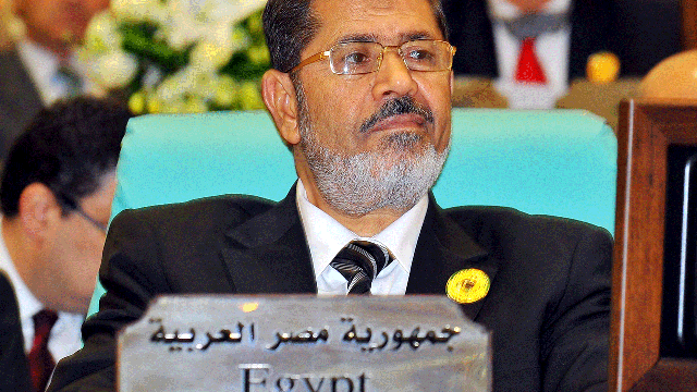 In this photo released by Saudi Press Agency, Egyptian President Mohammed Morsi attends the opening of an extraordinary session of the Organization of Islamic Conference in Mecca, Saudi Arabia, Tuesday, Aug. 14, 2012 