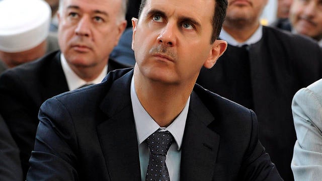 Syrian President Bashar Assad performs Eid prayers in the Hamad Mosque in Damascus, Syria, Aug. 19, 2012, in this photo released by the Syrian official news agency SANA. 