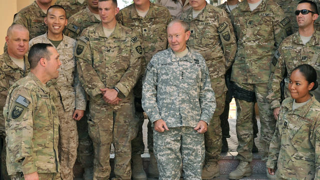 Gen. Martin Dempsey (C) listens to a soldier at the International Security Assistance Force (ISAF) headquarters in Kabul 