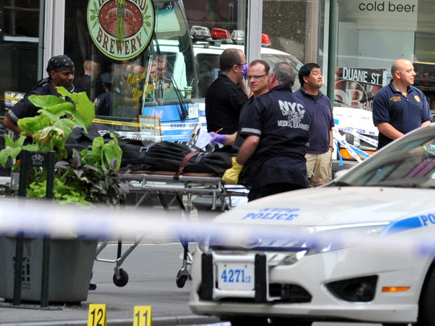 Investigators remove the body of a man who started a shootout near the Empire State Building Aug. 24, 2012, in New York. 