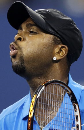 Donald Young reacts after losing a point to Roger Federer 