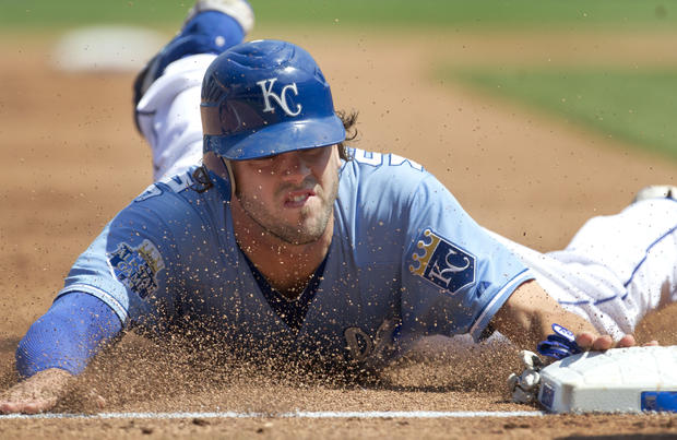 Mike Moustakas slides into third base  