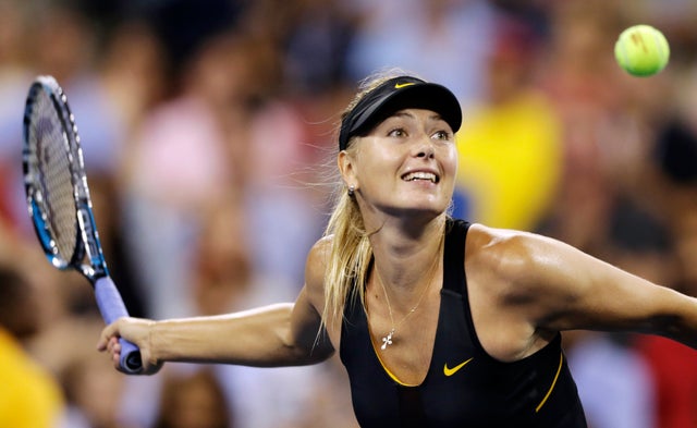 Maria Sharapova hits a ball into the crowd after defeating Nadia Petrova 