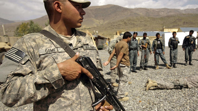 U.S. soldier stands guard during a training session for Afghan National Police 