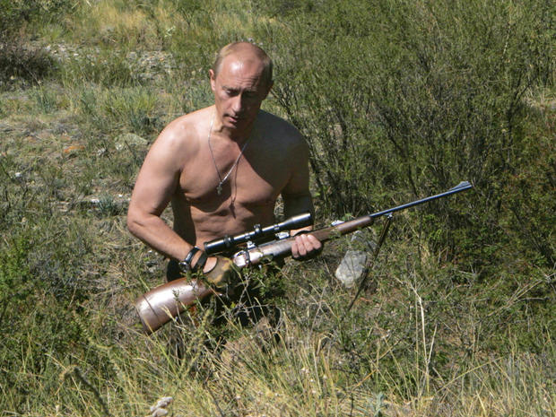 Russian Prime Minister Vladimir Putin carries a hunting rifle 