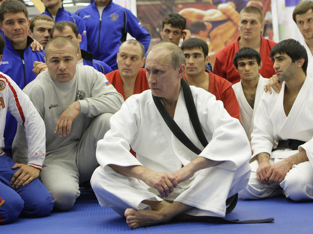 Vladimir Putin sits with a group at the Moscow sports complex 