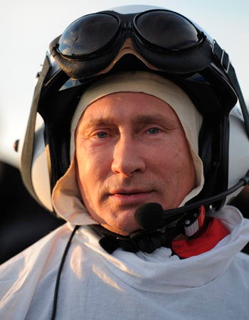 Russian President Vladimir Putin prepares for a flight in a motorized hang glider 