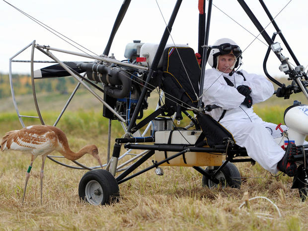Russian President Vladimir Putin waits in a motorized hang glider 