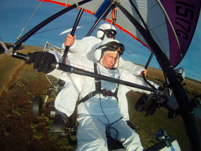 Russian President Vladimir Putin, flies in a motorized hang glider 