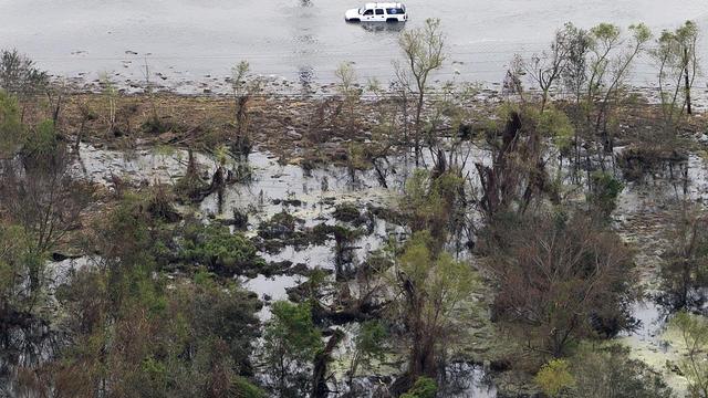 Aerial photo shows car in floodwaters in aftermath of Hurricane Isaac. in Plaquemines Parish, La., Wednesday. Several miles of coastline were tarred with weathered oil washing ashore days after Isaac raked Gulf Coast. 