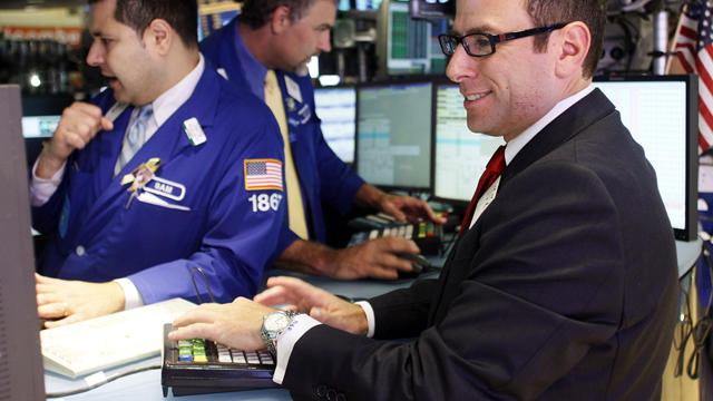 Specialist Michael A. Pistillo, right, works on the trading floor of the New York Stock Exchange shortly after the opening bell on Sept. 6, 2012. 