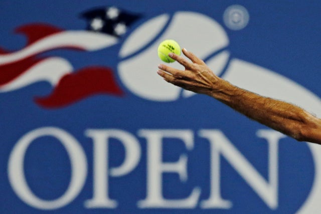 Roger Federer tosses the ball on his serve 