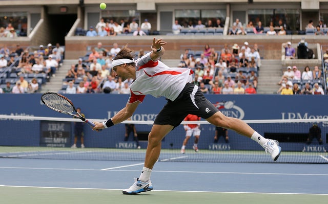 David Ferrer returns a shot against Janko Tipsarevic 