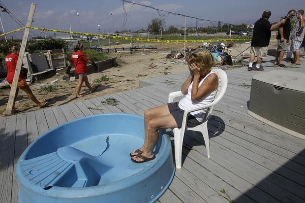 abana owner Janet Ryan is overcome by emotion as she sits on the porch at the Breezy Point Surf Club in New York, Saturday, Sept. 8, 2012, after a severe weather storm 