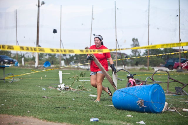 Lifeguard cleans up debris from a tornado that touched down on September 8, 2012 in the Breezy Point neighborhood of the Queens borough of New York City. The National Weather Service has issued a tornado watch as severe weather continues to move through N 
