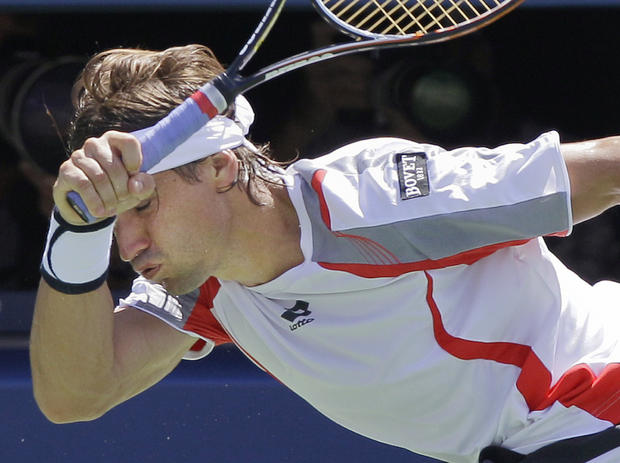 David Ferrer returns a shot to Serbia's Novak Djokovic 
