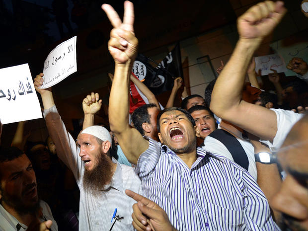 An Egyptian protester holds a sign that reads in Arabic "I sacrifice my soul for God's prophet" during a demonstration outside the U.S. Embassy in Cairo Sept. 11, 2012. 