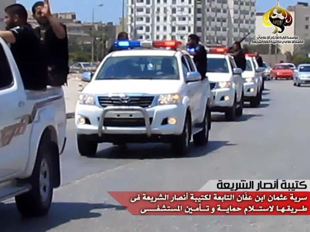 Militants from the Libyan Ansar al-Sharia group drive through Benghazi 