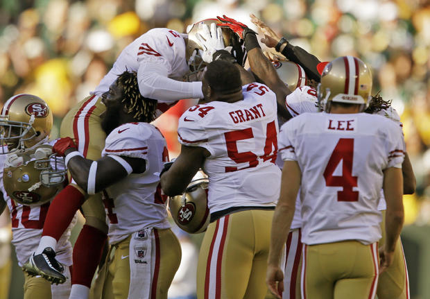 David Akers is congratulated by teammates  