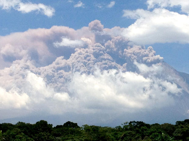 In this picture captured on a cell phone, plumes of smoke rise from the Volcan de Fuego or Volcano of Fire as seen from Palin, south of Guatemala City, Thursday, Sept. 13, 2012.  