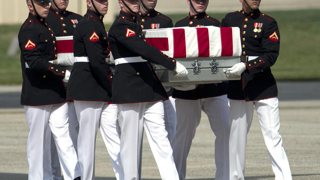 A carry team moves a flag-draped transfer case of the remains of one of the Americans killed this week in Benghazi, Libya, from a transport plane during the Transfer of Remains Ceremony, Friday, Sept. 14, 2012, at Andrews Air Force Base, Md. 