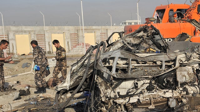 Afghan investigators inspect site of suicide attack in Kabul Tuesday 