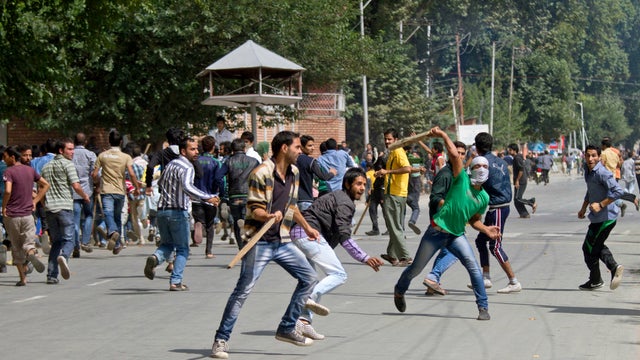 Kashmiri Muslim protesters hurl objects at Indian police during a protest in Srinagar, India, Tuesday, Sept. 18, 2012, as part of widespread anger across the Muslim world about a film ridiculing Islam's Prophet Muhammad. 